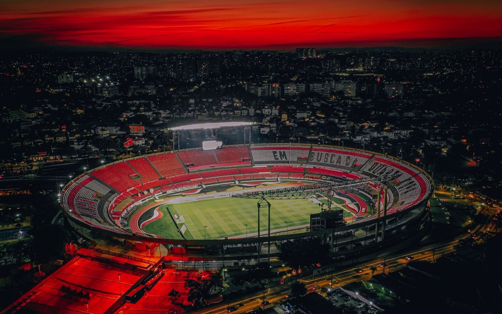 A stadium at night surrounded by a city